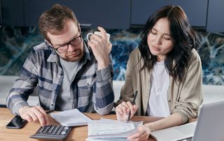 Couple Reviewing and Managing Their Bills Together